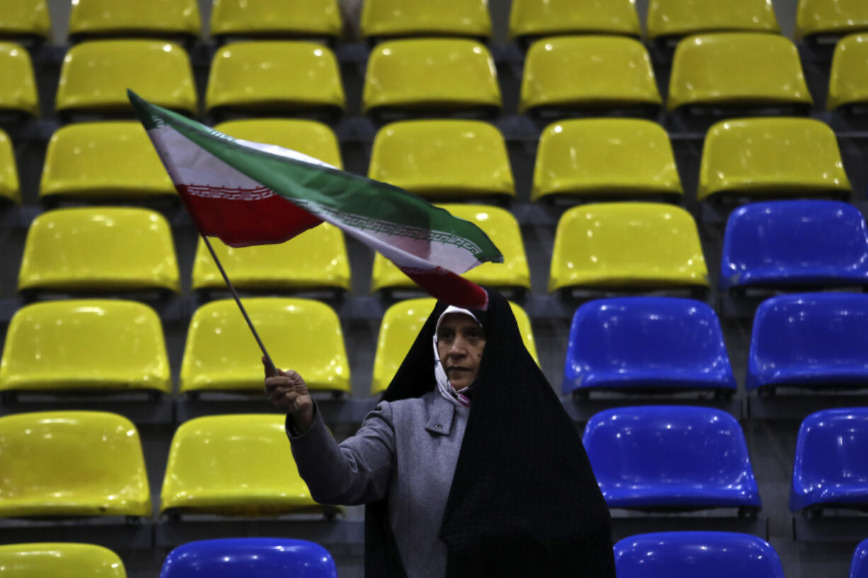 A supporter of a group of candidates waves Iranian flag during their election campaign rally ahead of the March 1, parliamentary and Assembly of Experts elections, in Tehran, Iran, Wednesday, Feb. 28, 2024. Iran is holding parliamentary elections this Friday, yet the real question may not be who gets elected but how many people actually turn out to vote. Separately, Iranians will also vote on Friday for members of the country&rsquo;s 88-seat Assembly of Experts, an eight-year term on a panel that will appoint the country&rsquo;s next supreme leader after Khamenei, 84.