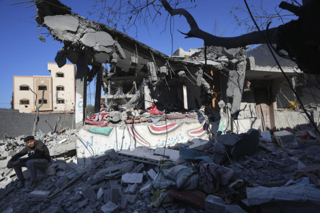 Palestinians inspect the rubble of the Al Daalese family building after an Israeli airstrike in Nusseirat refugee camp, central Gaza Strip, Thursday, Feb. 22, 2024.