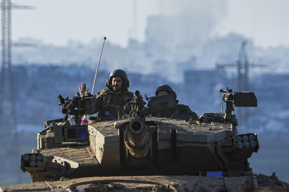 Israeli soldiers drive a tank on the border with the Gaza Strip, as seen from southern Israel, Sunday, Feb. 4, 2024. The army is battling Palestinian militants across Gaza in the war ignited by Hamas&#039; Oct. 7 attack into Israel.