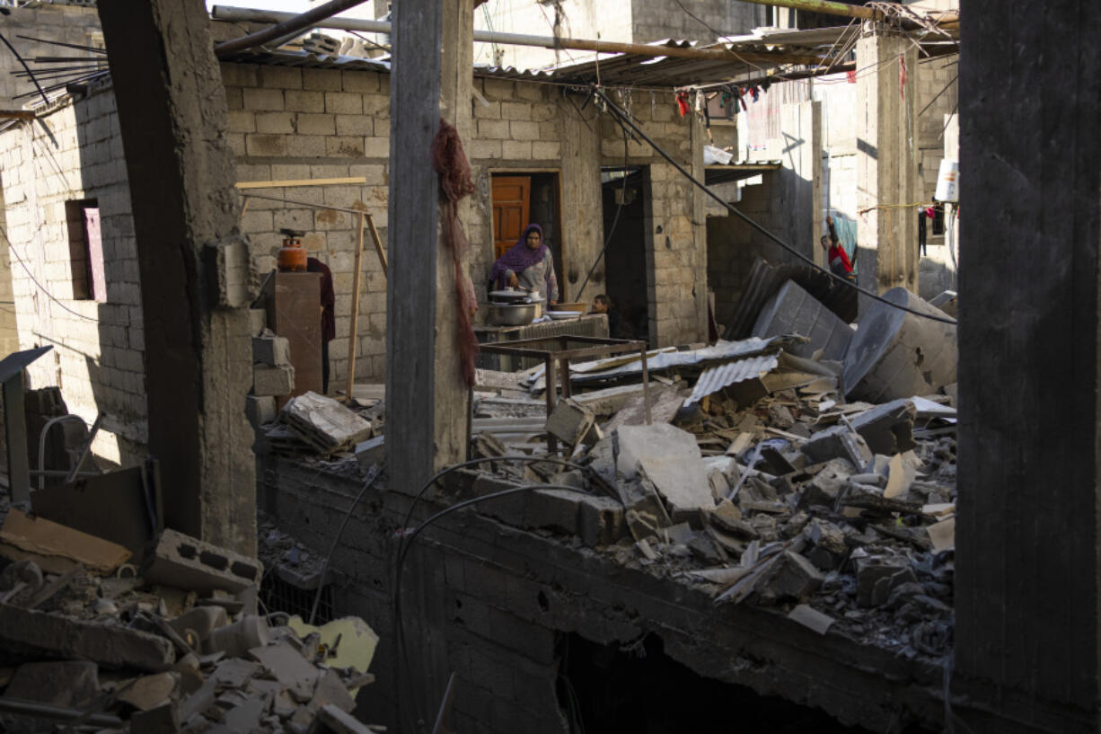 Palestinians look at the destruction after an Israeli strike in Rafah, southern Gaza Strip, Thursday, Feb. 8, 2024.