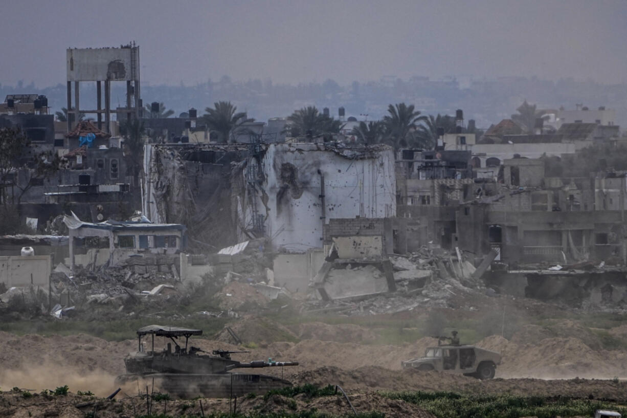 Israeli soldiers operate inside the Gaza Strip, as seen from southern Israel, Tuesday, Feb. 13, 2024. The army is battling Palestinian militants across Gaza in the war ignited by Hamas&rsquo; Oct. 7 attack into Israel.