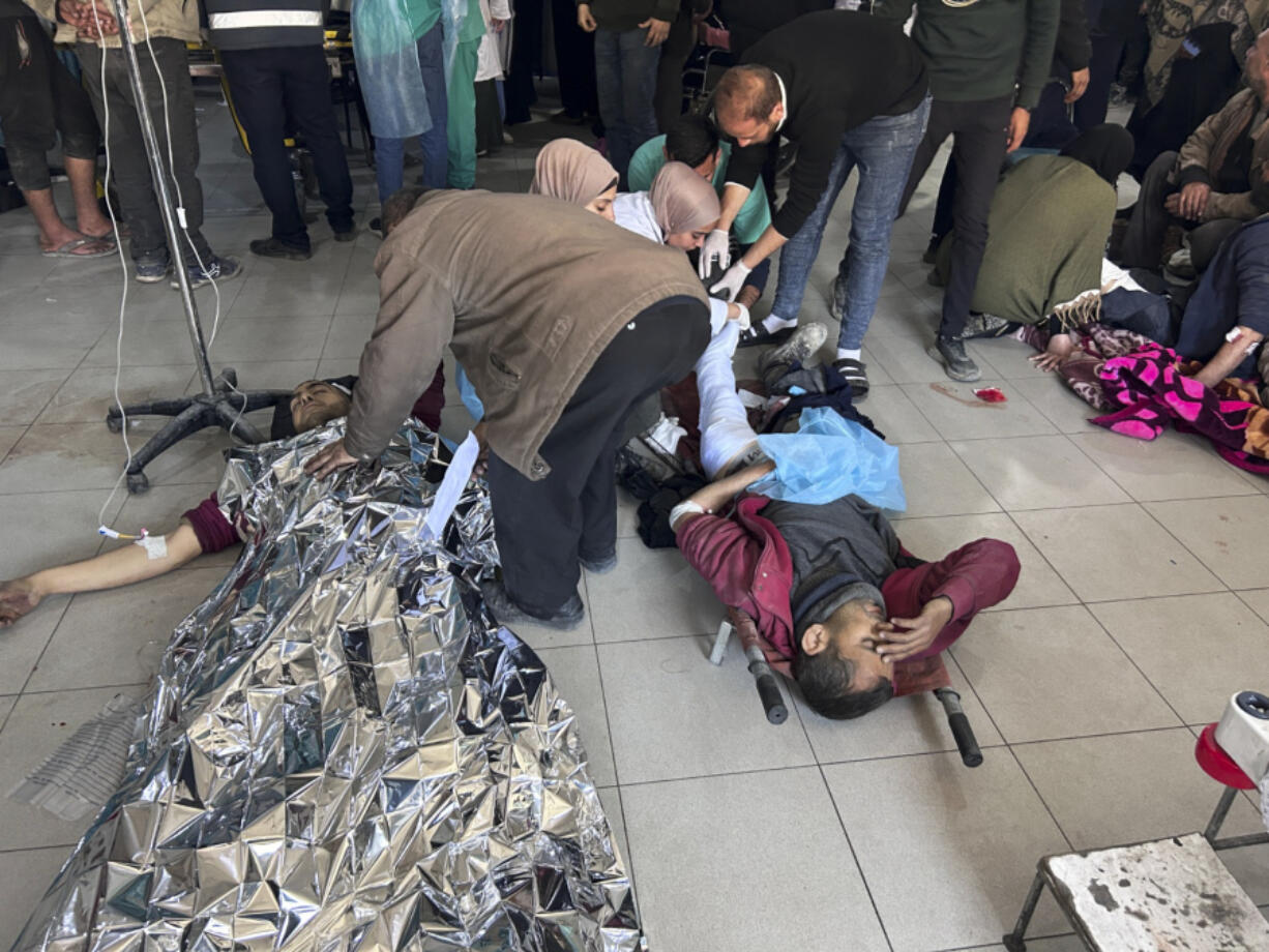Palestinians wounded in an Israeli strike while waiting for humanitarian aid on the beach in Gaza City are treated in Shifa Hospital on Thursday, Feb. 29, 2024.