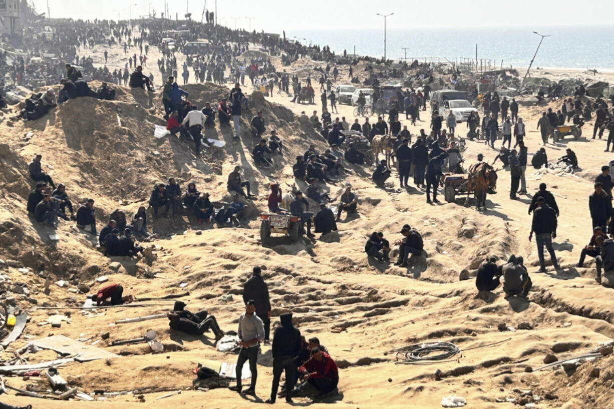 Palestinians wait for humanitarian aid Sunday on a beachfront in Gaza City, Gaza Strip.
