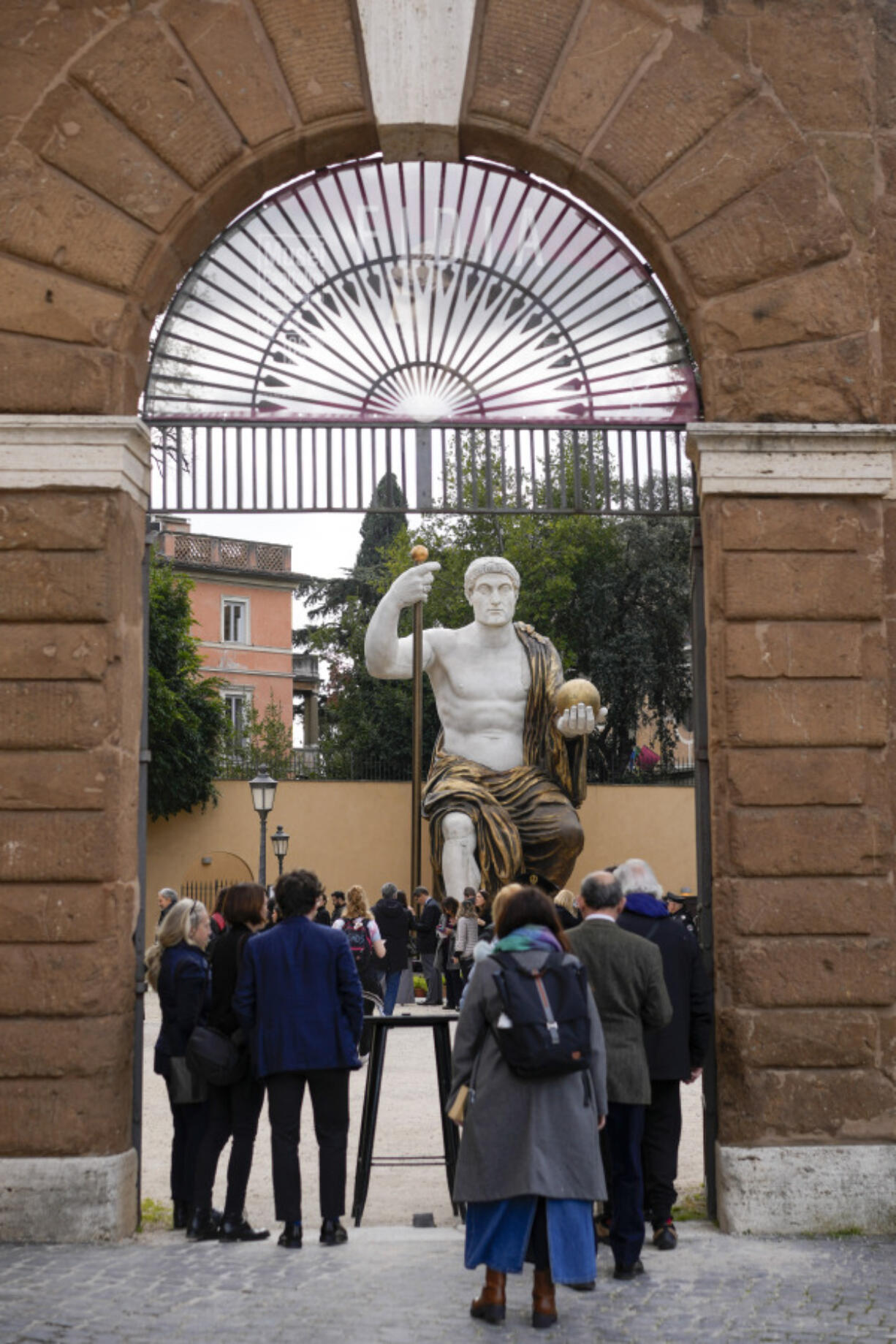 Visitors admire a massive replica of the statue Roman Emperor Constantine commissioned for himself after 312 AD that was built using 3D technology from scans of the nine giant original marble body parts that remain, as it was unveiled Tuesday in Rome.