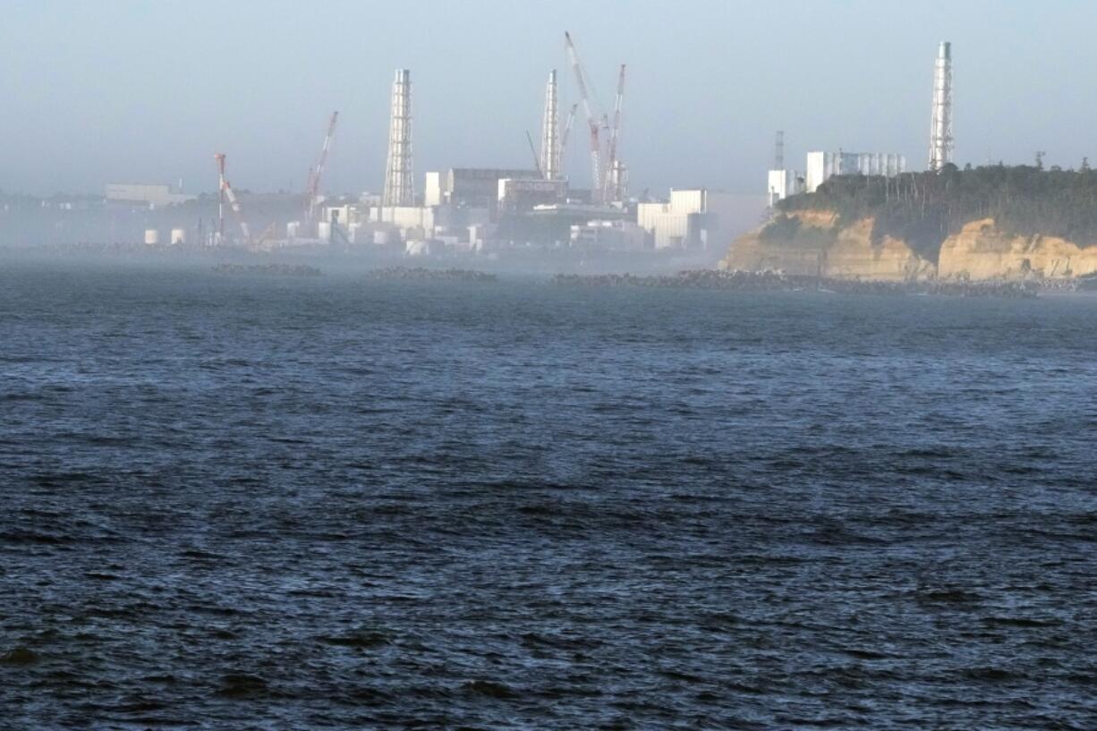 FILE - The Fukushima Daiichi nuclear power plant, damaged by a massive March 11, 2011, earthquake and tsunami, is seen from the nearby Ukedo fishing port in Namie town, northeastern Japan, on Aug. 24, 2023. The operator of the wrecked Fukushima Daiichi nuclear power plant said there is no safety worries or change to the plant&rsquo;s decommissioning plans even though the deadly Jan. 1, 2024 earthquake in Japan&rsquo;s north-central region caused some damages to a local idled nuclear plant, which rekindled safety concerns and prompted a regulatory body to order a close examination.