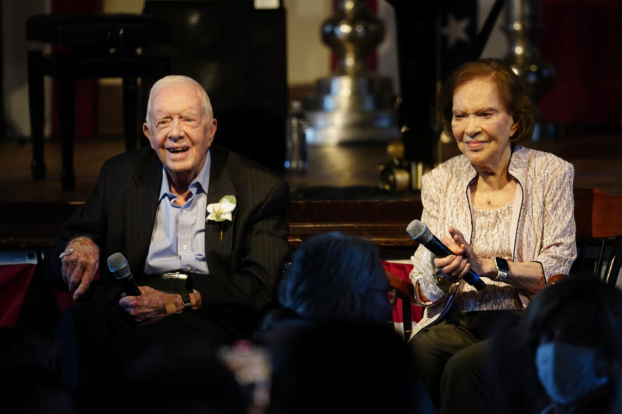 FILE- Former President Jimmy Carter and his wife former First Lady Rosalynn Carter sit together during a reception to celebrate their 75th anniversary Saturday, July 10, 2021, in Plains, Ga. In the year since Jimmy Carter first entered home hospice care, the 39th president has celebrated his 99th birthday, enjoyed tributes to his legacy and outlived his wife of 77 years. Rosalynn Carter, who died in November 2023 after suffering from dementia, spent just a few days under hospice.
