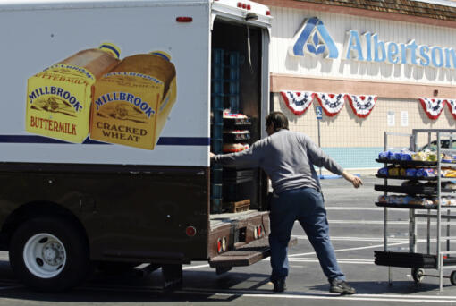 FILE - Mitch Maddox, a bread route salesman, loads bread Tuesday, May 30, 2006, outside the Eagle Rock Albertsons store in Los Angeles. The Federal Trade Commission on Monday, Feb.