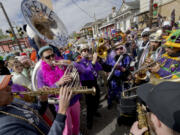 The Krewe du Belge plays during the Society of Saint Anne parade through Bywater and Marigny neighborhoods on Mardi Gras Day in New Orleans, Tuesday, Feb. 13, 2024.