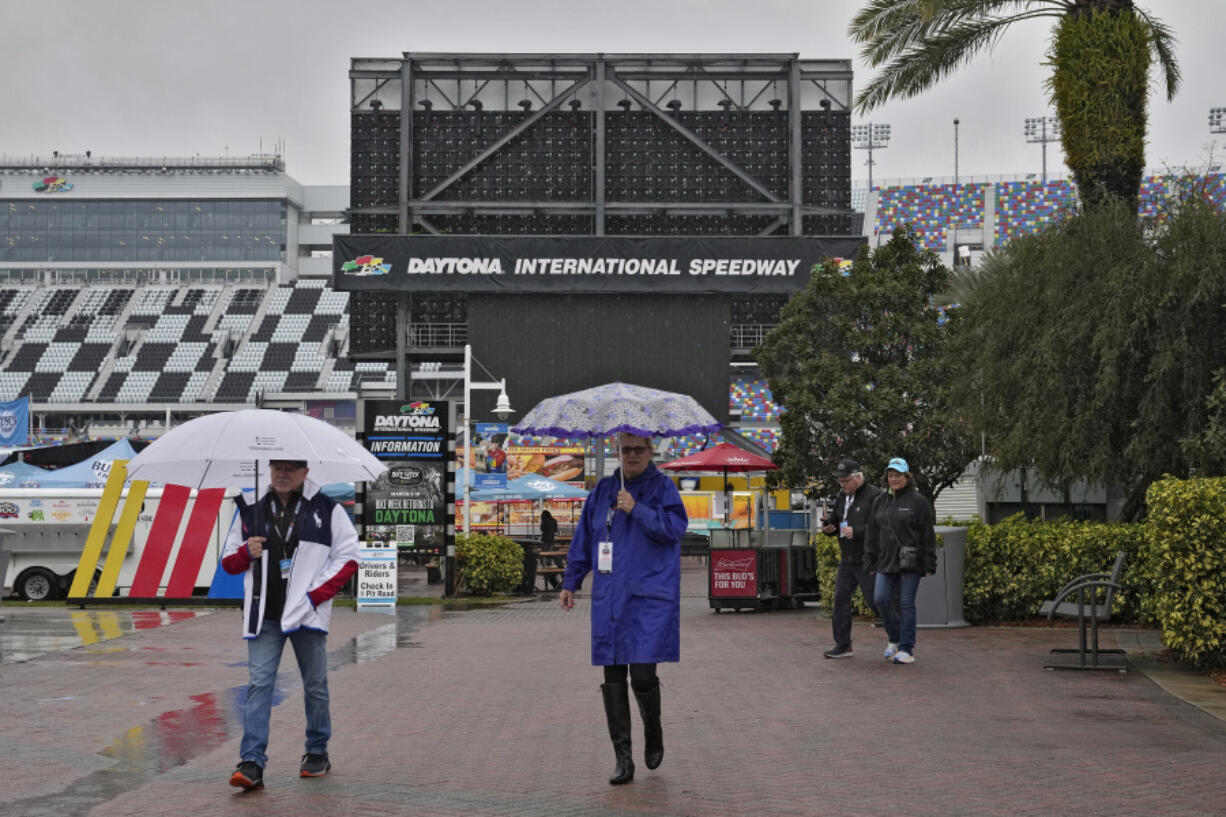 Fans leave the track after the NASCAR Daytona 500 auto race was rained out Sunday, Feb. 18, 2024, at Daytona International Speedway in Daytona Beach, Fla. The race is rescheduled for Monday afternoon.
