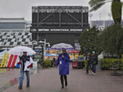 Fans leave the track after the NASCAR Daytona 500 auto race was rained out Sunday, Feb. 18, 2024, at Daytona International Speedway in Daytona Beach, Fla. The race is rescheduled for Monday afternoon.