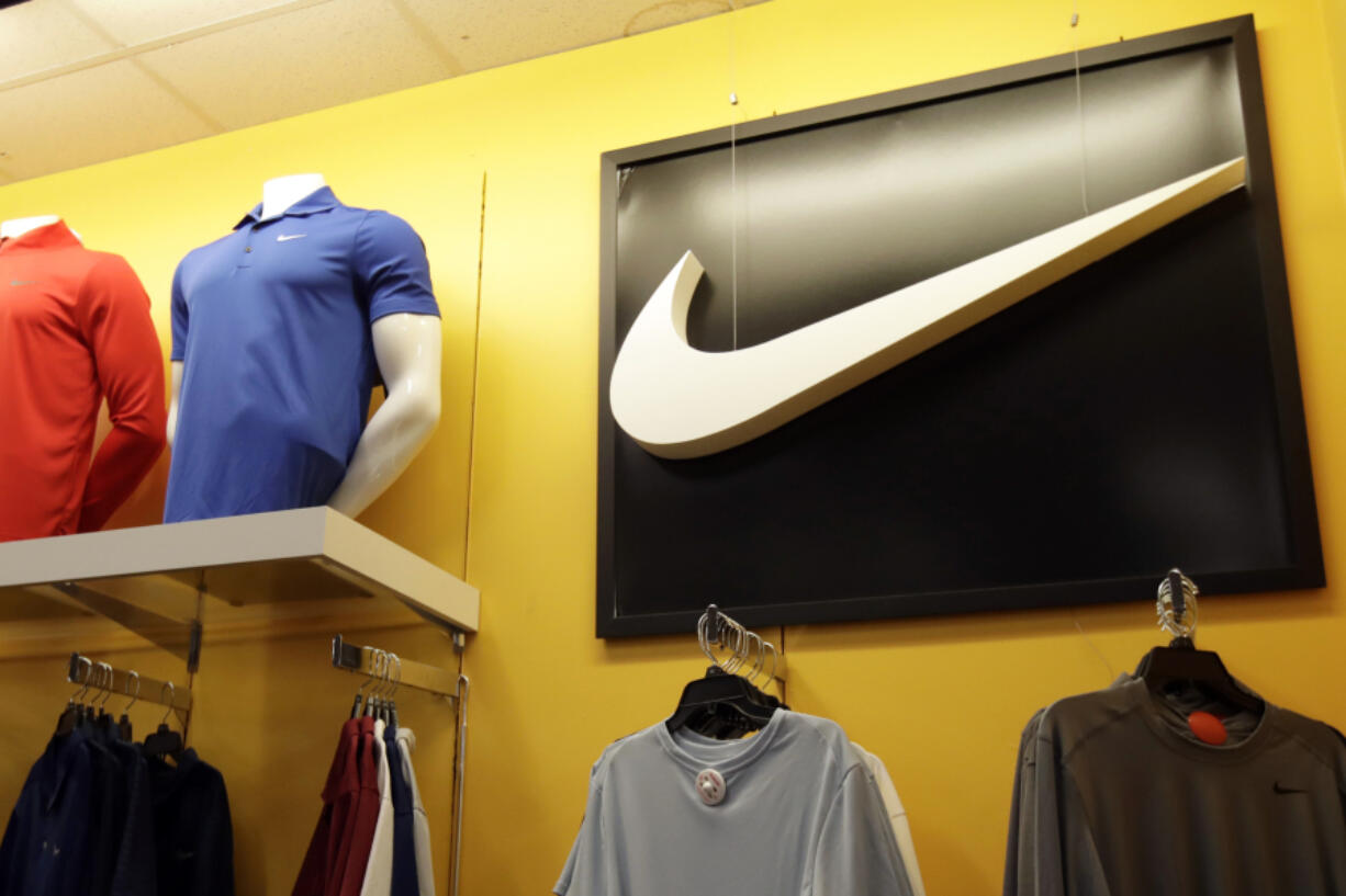 FILE - In this Nov. 29, 2019, file photo Nike clothes are displayed at a store in Colma, Calif. Nike is cutting 2% of its global workforce, or a little over 1,600 jobs, as the athletic wear giant aims to cut costs and reinvests its savings into what it sees as big growth areas like sport, health and wellness.