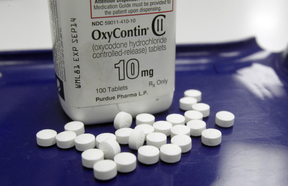 FILE - In this Feb. 19, 2013 file photo, OxyContin pills are arranged for a photo at a pharmacy in Montpelier, Vt. Companies and U.S. government entities have agreed to settlements of lawsuits over the toll of opioids totaling more than $50 billion.