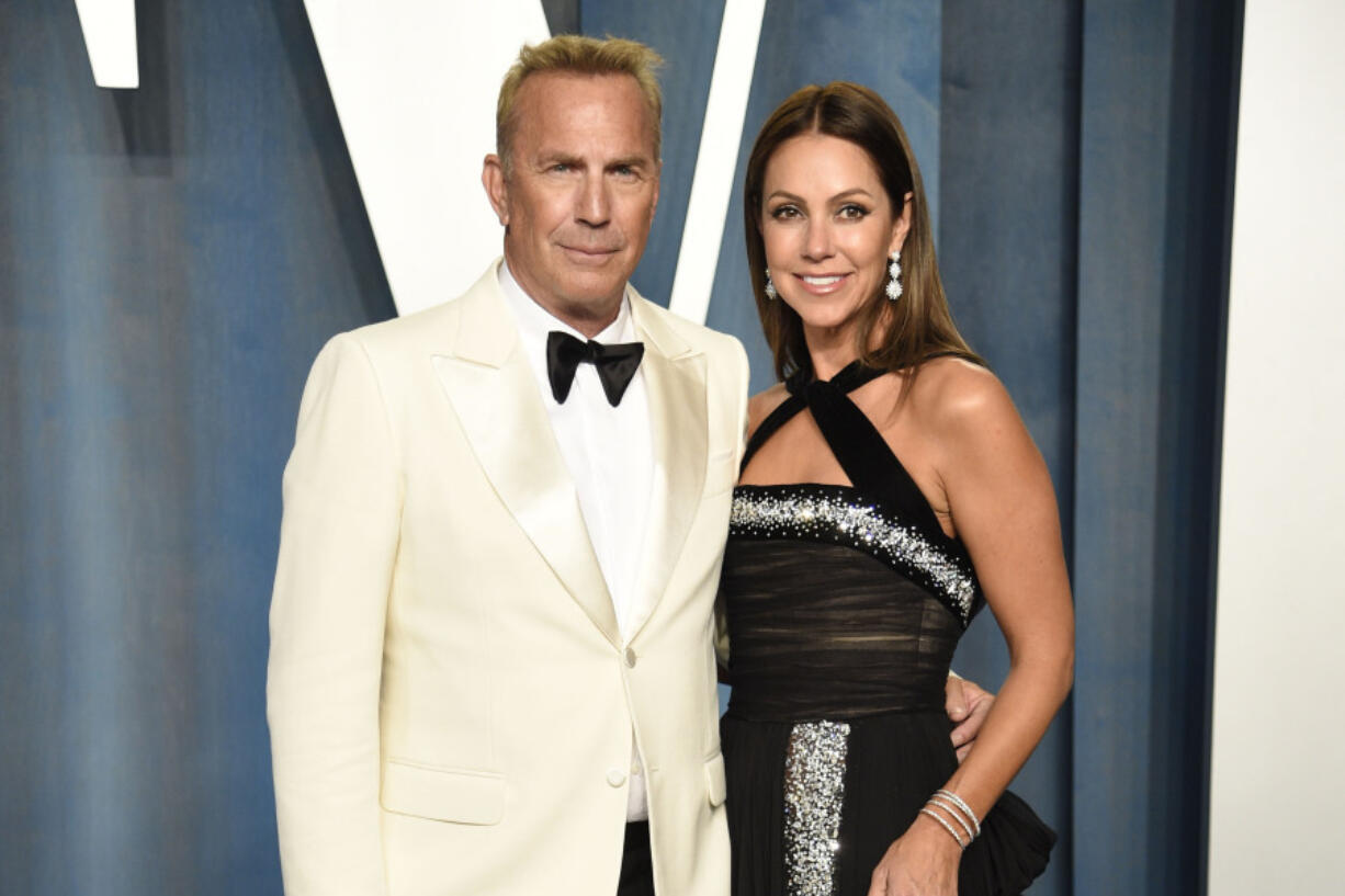 FILE - Kevin Costner, left, and Christine Baumgartner arrive at the Vanity Fair Oscar Party, March 27, 2022, in Beverly Hills, Calif. A judge has declared that Costner and his wife of nearly two decades, Baumgartner, are now legally divorced, according to court records filed Tuesday, Feb. 20, 2024.
