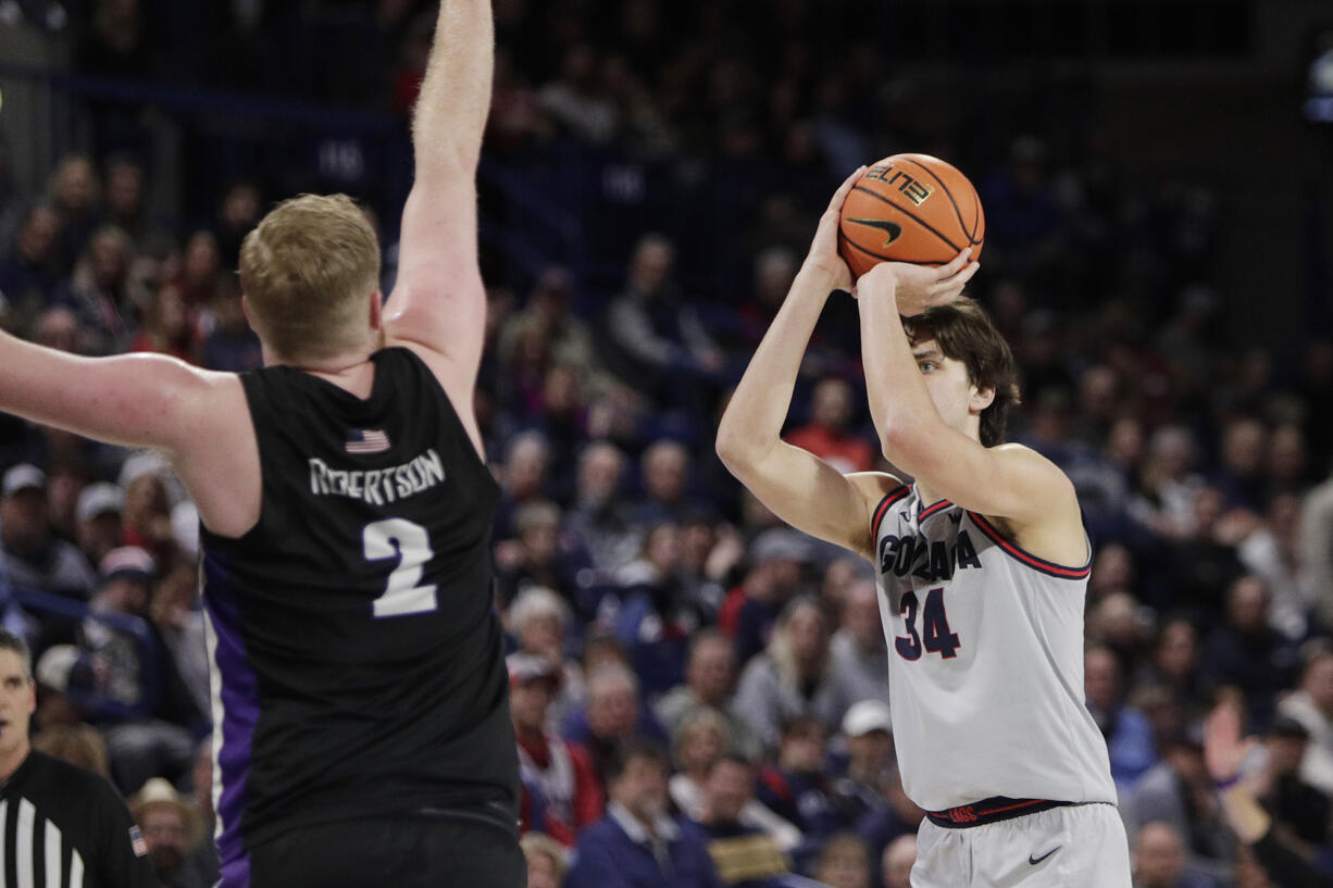 Gonzaga forward Braden Huff (34) shoots while pressured by Portland guard Tyler Robertson (2) during the second half of an NCAA college basketball game, Wednesday, Feb. 7, 2024, in Spokane, Wash.