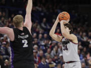 Gonzaga forward Braden Huff (34) shoots while pressured by Portland guard Tyler Robertson (2) during the second half of an NCAA college basketball game, Wednesday, Feb. 7, 2024, in Spokane, Wash.