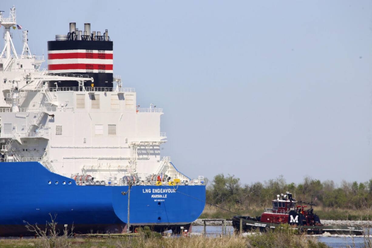 File - A tugboat helps guide a French ship, the LNG Endeavor, near Hackberry, La., on March 31, 2022. The ship was on its way to the Cameron LNG export facility to pick up liquified natural gas. Attacks by Yemen&rsquo;s Houthi rebels are posing a new threat to the future of energy supplies to the European Union, which relies on imported oil and natural gas.