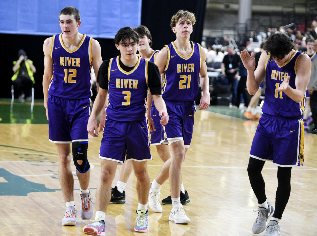 Columbia River players, from left, Miles Fitzwilson, Ari Richardson, Carter Sheron and John Reeder celebrate a 3-point basket by Richardson during a Class 2A boys basketball state playoff game against Anacortes on Wednesday, Feb. 28, 2024 in Yakima.