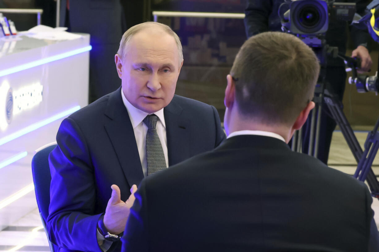 Russian President Vladimir Putin, left, speaks during his interview with correspondent of Russian state television Rossiya 1 Pavel Zarubin in Moscow, Wednesday, Feb. 14, 2024.