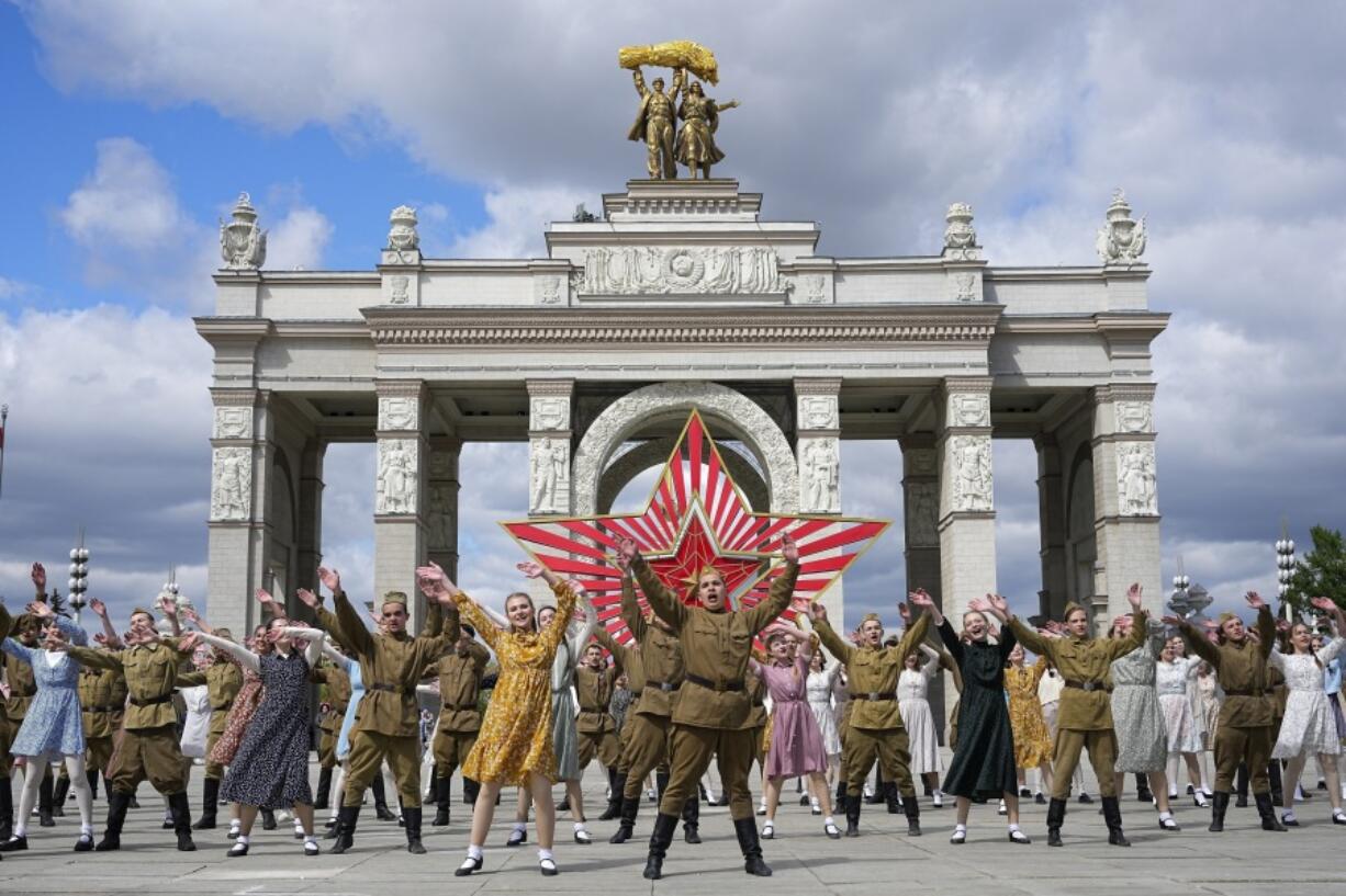 FILE - Moscow students dressed in the fashion of the middle of the last century and Soviet style uniform perform &ldquo;Victory Waltz&rdquo; as a part of Victory Day celebration in front of the historical main gates of VDNKh, The Exhibition of Achievements of National Economy, with the red star in the background in Moscow, Russia, Saturday, May 6, 2023. In Russia, history has long become a propaganda tool used to advance the Kremlin&rsquo;s political goals. In an effort to rally people around the flag, the authorities have sought to magnify the country&rsquo;s past victories while glossing over the more sordid chapters of its history.