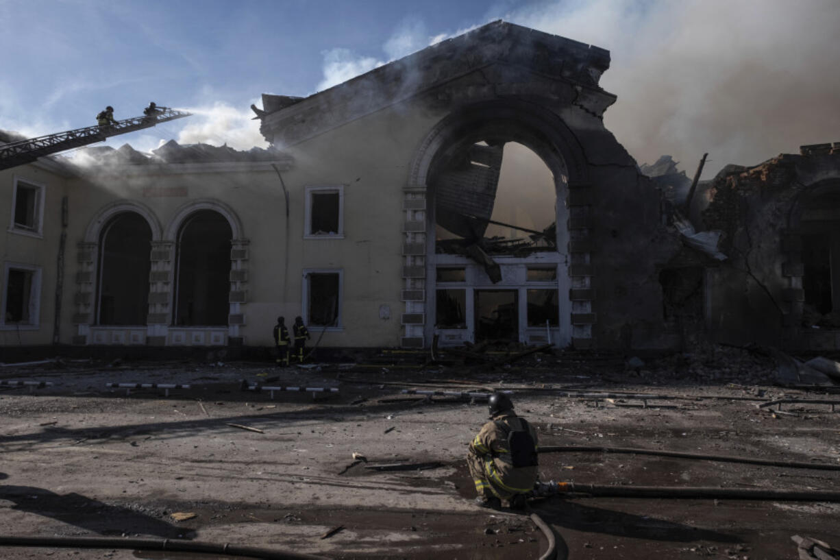 Firefighters put out the fire at a railway station after Russian shelling in the eastern city of Kostiantynivka, Donetsk region, Ukraine, Sunday, Feb. 25, 2024. A woman was wounded and a railway station, shops and residential houses were badly damaged amid heavy bombing.