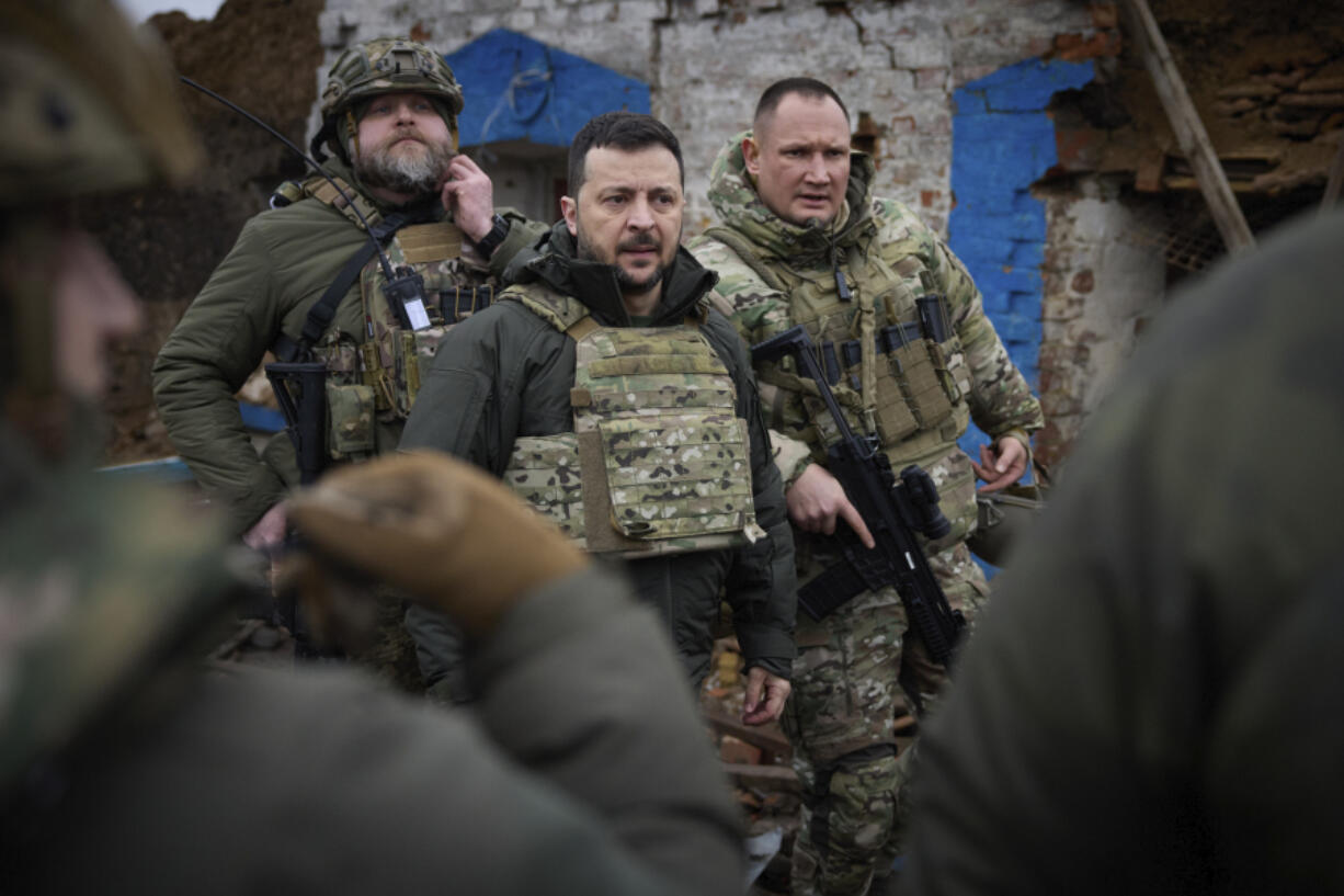 In this photo provided by the Ukrainian Presidential Press Office, Ukrainian President Volodymyr Zelenskyy, centre, during his visit to Zaporizhzhia region, the site of fierce battles with the Russian troops in Ukraine, Sunday, Feb. 4, 2024.