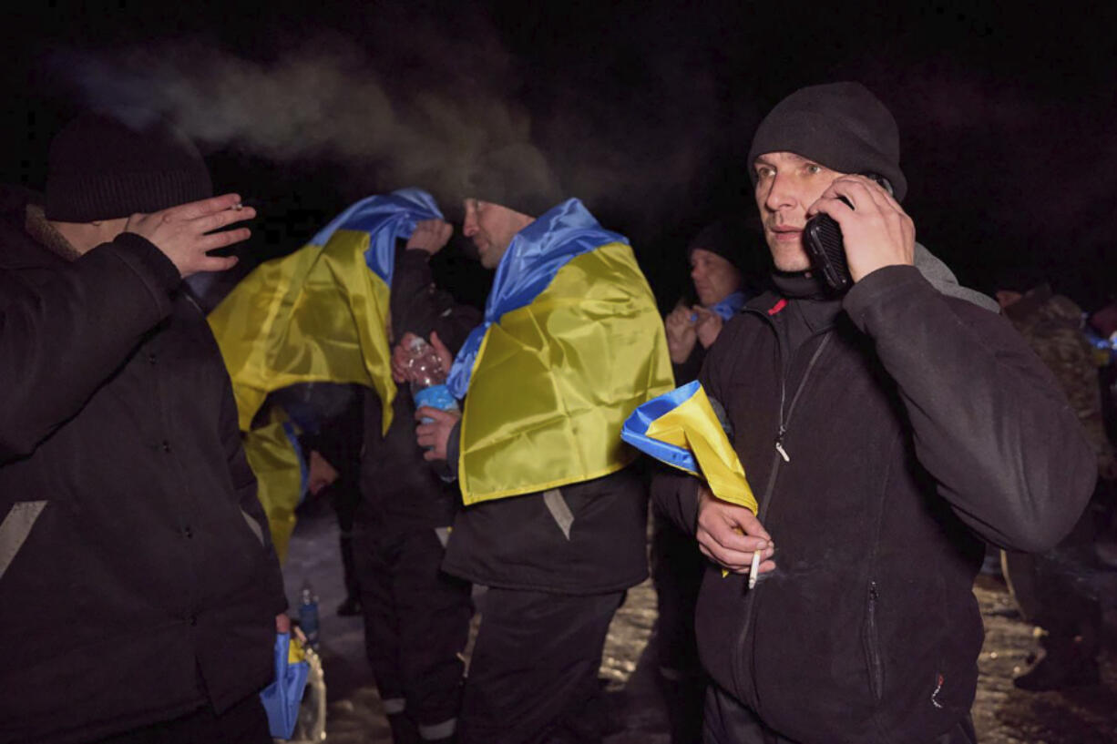 In this photo provided by the Ukrainian Presidential Press Office on Thursday, Feb. 8, 2024, Ukrainian prisoners of war react after a prisoners exchange at an undisclosed location in Ukraine. Russia and Ukraine have exchanged about 100 prisoners of war each, Ukraine&rsquo;s officials said.