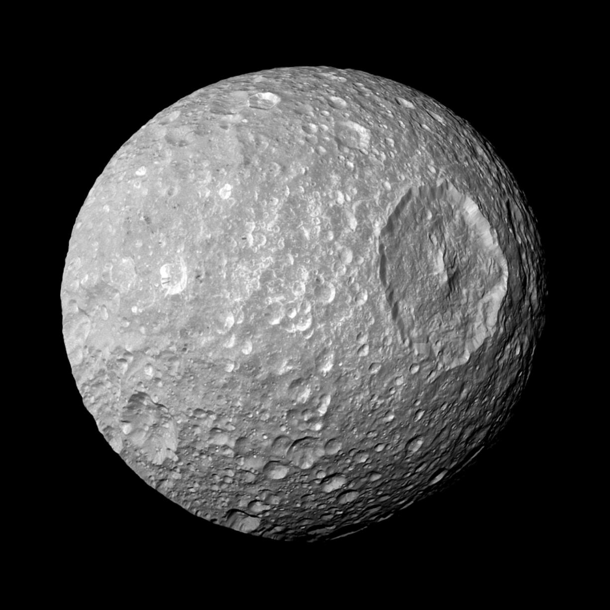 Saturn&rsquo;s moon Mimas and it&rsquo;s large Herschel Crater, is captured by the Cassini spacecraft. .