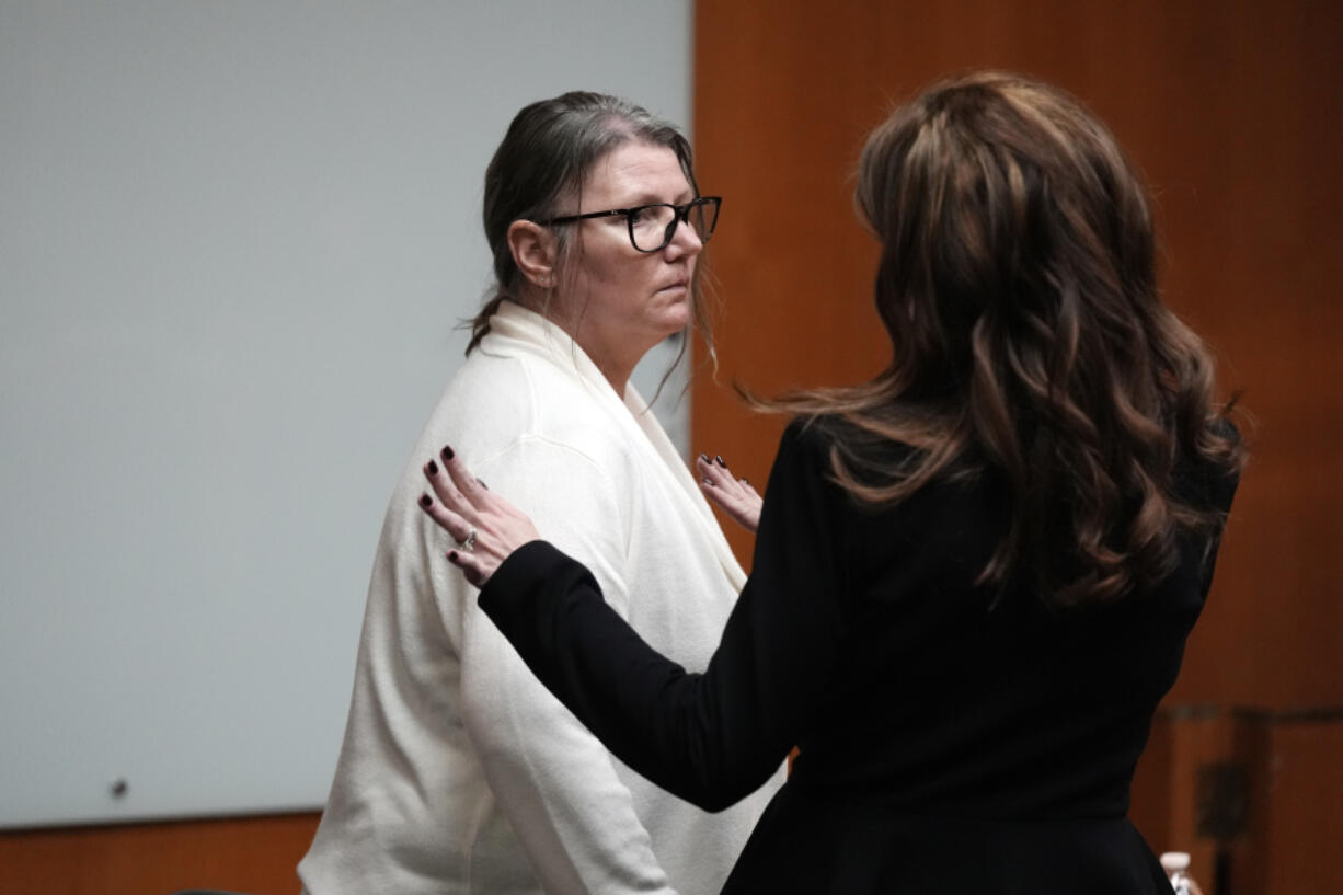 Jennifer Crumbley, left, looks to attorney Shanon Smith, Monday, Feb. 5, 2024, in Pontiac, Mich. The jury will return on Tuesday and continue deliberating in an unusual trial against a school shooter&rsquo;s mother. The deliberations beginning Monday could send Crumbley to prison if she is convicted of contributing to the deaths of four students in 2021.