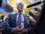 FILE - Sen. John Cornyn, R-Texas, is surrounded by reporters as he heads to the chamber at the Capitol in Washington, Feb. 7, 2024. (AP Photo/J.