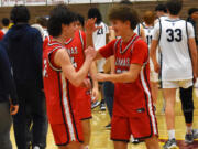 Camas freshman Carter Morgan (right) celebrates with junior Jace VanVoorhis after the Papermakers' 40-38 win over Skyview in a 4A Greater St. Helens League boys basketball tiebreaker game at Prairie High School on Wednesday, Feb. 7, 2024.