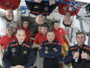 In this image from video provided by NASA, the 11 International Space Station crew members representing Expedition 70 (red shirts) and Axiom Space 3 (dark blue suits) crews gather for a farewell ceremony calling down to mission controllers on Earth on Friday, Feb. 2, 2024. Front row from left are Italy&rsquo;s Walter Villadei, Turkey&rsquo;s Alper Gezeravci and Sweden&rsquo;s Marcus Wandt. Above them hanging upside down in blue is Axiom Space&rsquo;s Michael Lopez-Alegria, a former NASA astronaut.