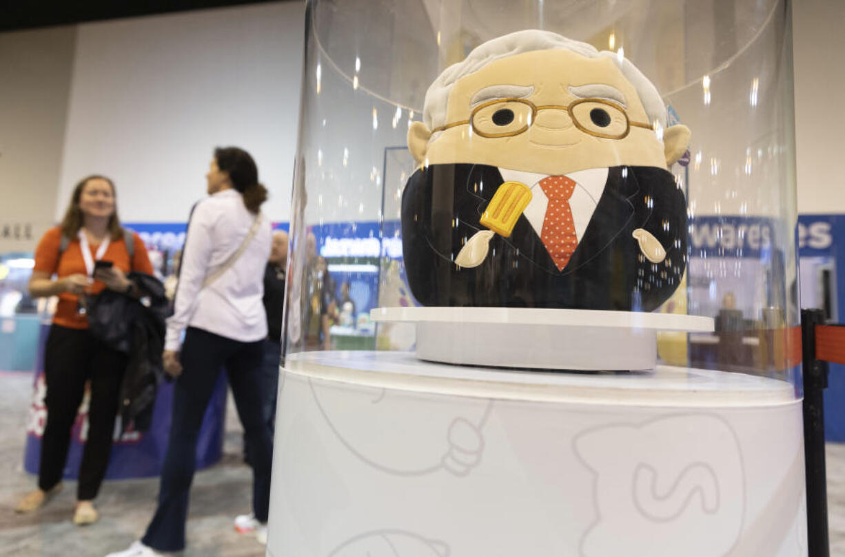 FILE - The Squishmallows booth sells toys modeled after Warren Buffett, pictured, and Charlie Munger in the exhibit hall for the Berkshire Hathaway annual meeting, Saturday, May 6, 2023, in Omaha, Neb. In a lawsuit filed Monday, Feb. 12, 2024, Kelly Toys and parent company Jazwares accused Build-A-Bear&rsquo;s new &ldquo;Skoosherz&rdquo; line of copying Squishmallows&rsquo; look and feel. Skoosherz toys have the &ldquo;same distinctive trade dress&rdquo; of Squishmallows, the complaint said &mdash; pointing to shape, face style, coloring and fabric similarities. (AP Photo/Rebecca S.