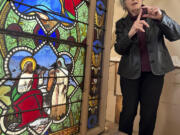 Holy Cross professor and stained-glass expert Virginia Raguin speaks to a group of middle school students May 1, 2023, while standing by a nearly 150-year-old stained-glass window that depicts Christ speaking to a Samaritan woman in a Warren, R.I., church.