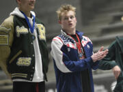 Owen Robertson of Union applauds for state champion Jaiden Sreenivasan (left) of Redmond after Robertson placed second in the 200 freestyle at the Class 4A boys swimming state championships at the King County Aquatic Center in Federal Way on Saturday, Feb. 17, 2024.