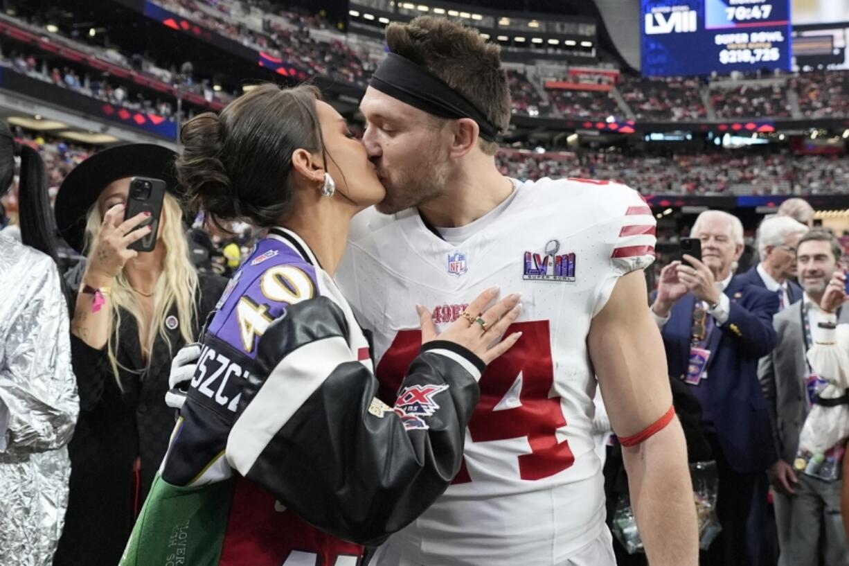 San Francisco 49ers fullback Kyle Juszczyk kisses his wife, Kristin Juszczyk, before the NFL Super Bowl 58 football game Sunday against the Kansas City Chiefs in Las Vegas.