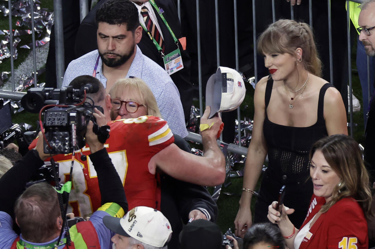 Kansas City Chiefs tight end Travis Kelce (87) celebrates with his mom Donna as Taylor Swift looks on after the Chiefs defeated the San Francisco 49ers in the NFL Super Bowl 58 football game Sunday, Feb. 11, 2024, in Las Vegas. The Chiefs won 25-22 against the 49ers.