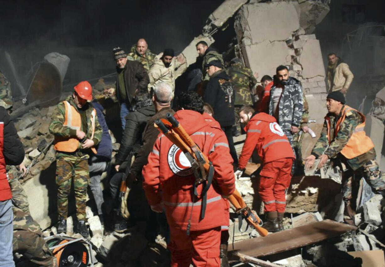 In this photo released by the Syrian official news agency SANA,  Syrian security forces and civil defence workers search for victims under the rubbles of a building that was destroyed by Israeli airstrikes, in Homs, Syria, late Tuesday, Feb. 6, 2024. Syria&rsquo;s military says Israeli airstrikes over the central city of Homs and nearby areas have killed and wounded civilians.