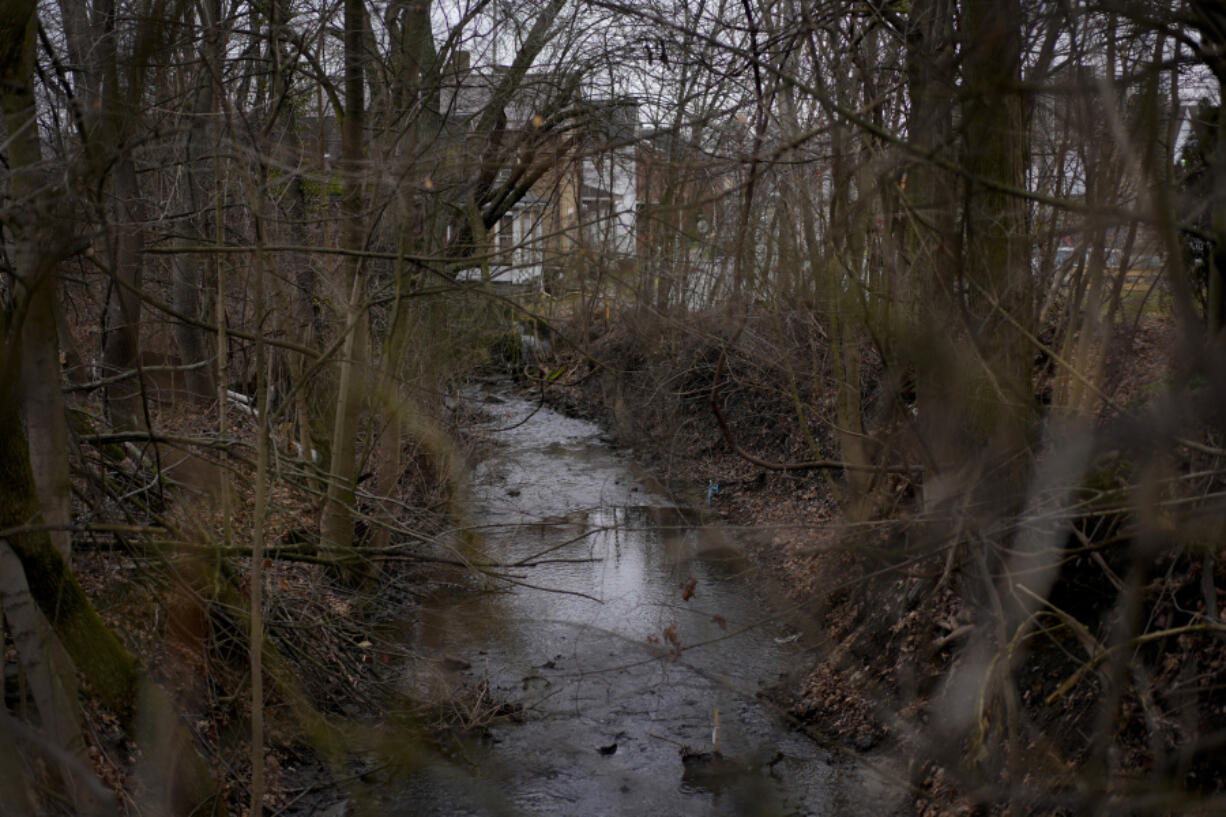 Sulphur Run Creek flows near homes in East Palestine, Ohio, on Tuesday, Jan. 30, 2024. Daily life largely returned to normal for residents of East Palestine, Ohio, months after a Norfolk Southern train derailed and spilled a cocktail of hazardous chemicals that caught fire a year ago, but the worries and fears are always there.