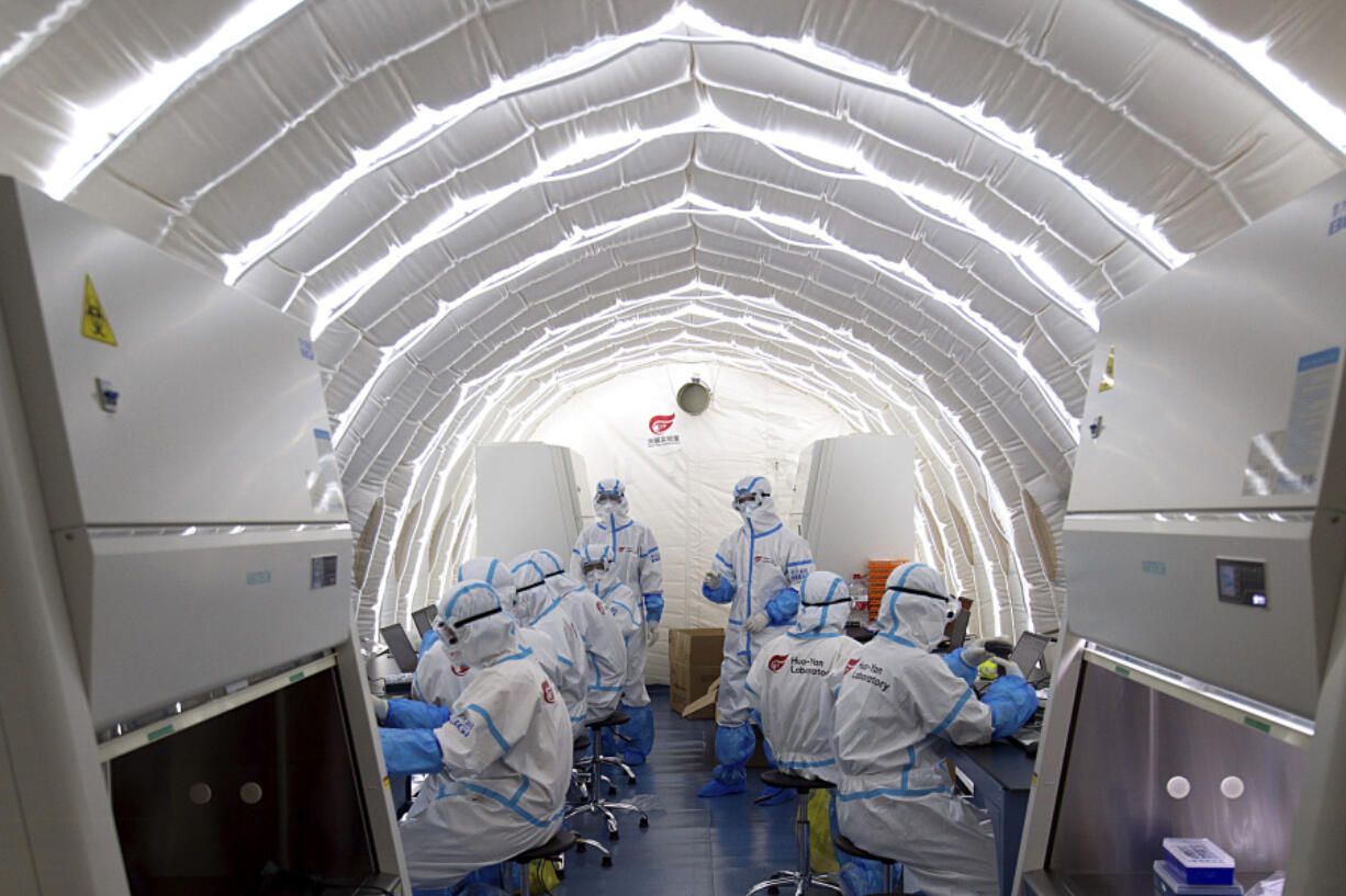 FILE - In this file photo released by China&rsquo;s Xinhua News Agency, staff members work in an inflatable COVID-19 testing lab provided by Chinese biotech company BGI Genomics, a subsidiary of BGI Group, in Beijing, June 23, 2020. Members of Congress are raising alarms about what they see as America&rsquo;s failure to compete with China in biotechnology, with risks to U.S. national security and commercial interests. But as the countries&rsquo; rivalry expands into the biotech industry, some say that shutting out Chinese companies would only hurt the U.S.