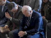 President Joe Biden, with from left, House Minority Leader Hakeem Jeffries, D-N.Y., and House Speaker Mike Johnson of La., pray and listen Feb. 1 during the National Prayer Breakfast at the Capitol in Washington. Johnson has spoken in the past of his belief America was founded as a Christian nation. Biden, while citing his own Catholic faith, has spoken of values shared by people of &ldquo;any other faith, or no faith at all.&rdquo; (J.