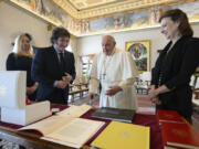 In this image distributed by Vatican Media, Argentine President Javier Milei, second from left, his sister and Secretary-General of the Presidency Karina Milei, left, and Foreign Minister Diana Mondino, right, exchange gifts with Pope Francis as they arrive in the pontiff&#039;s studio at The Vatican for a private audience, Monday, Feb. 12, 2024. Milei, who will meet Italian President Sergio Mattarella and Italian Premier Giorgia Meloni later in the day, attended the canonization of the first Argentine female saint, Mar&iacute;a Antonia de Paz y Figueroa also known as &quot;Mama Antula&quot; in St. Peter&#039;s Basilica on Sunday. In the background is Italian Renaissance painter Pietro Cristofaro Vannucci known as Il Perugino&#039;s &#039;The resurrection of Christ&#039; (1499).