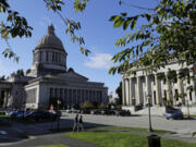 FILE - The afternoon sun illuminates the Legislative Building, left, at the Capitol in Olympia, Wash, Oct. 9, 2018. In a Tuesday, Feb. 6, 2024, vote, the Washington state Senate unanimously approved legislation that would ban police from hog-tying suspects, a restraint technique that has long drawn concern due to the risk of suffocation. (AP Photo/Ted S.