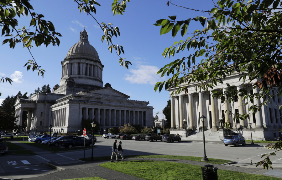 FILE - The afternoon sun illuminates the Legislative Building, left, at the Capitol in Olympia, Wash, Oct. 9, 2018. In a Tuesday, Feb. 6, 2024, vote, the Washington state Senate unanimously approved legislation that would ban police from hog-tying suspects, a restraint technique that has long drawn concern due to the risk of suffocation. (AP Photo/Ted S.