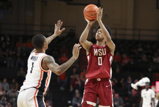 Washington State forward Jaylen Wells (0) shoots over Oregon State guard Christian Wright (1) during the second half of an NCAA college basketball game Thursday, Feb. 8, 2024, in Corvallis, Ore.