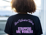 Andrea, no last name given, who works as a stripper in Seattle area clubs, poses for a portrait at her apartment, Thursday, Feb. 1, 2024, in Seattle. Andrea is among those fighting for bills to pass in the state Legislature that would expand statewide protections to workers, like having a security guard at each club, keypad codes to enter dressing rooms and de-escalation training.