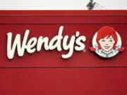 FILE - The Wendy&#039;s sign is seen at a restaurant, Jan. 23, 2023, in Pittsburgh. Wendy&#039;s is looking to test having the prices of its menu items fluctuate throughout the day based on demand, implementing a strategy that has already taken hold with ride-sharing companies and ticket sellers. (AP Photo/Gene J.