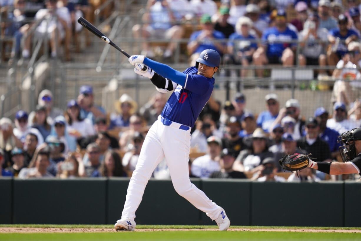 Los Angeles Dodgers designated hitter Shohei Ohtani grounds in to a double play during the third inning of a spring training baseball game against the Chicago White Sox in Phoenix, Tuesday, Feb. 27, 2024.