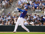 Los Angeles Dodgers designated hitter Shohei Ohtani grounds in to a double play during the third inning of a spring training baseball game against the Chicago White Sox in Phoenix, Tuesday, Feb. 27, 2024.