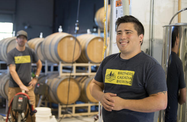 Matt Ellis, left, and Jason Bos discuss their experiences brewing beer at Brothers Cascadia Brewing in Hazel Dell in 2017.