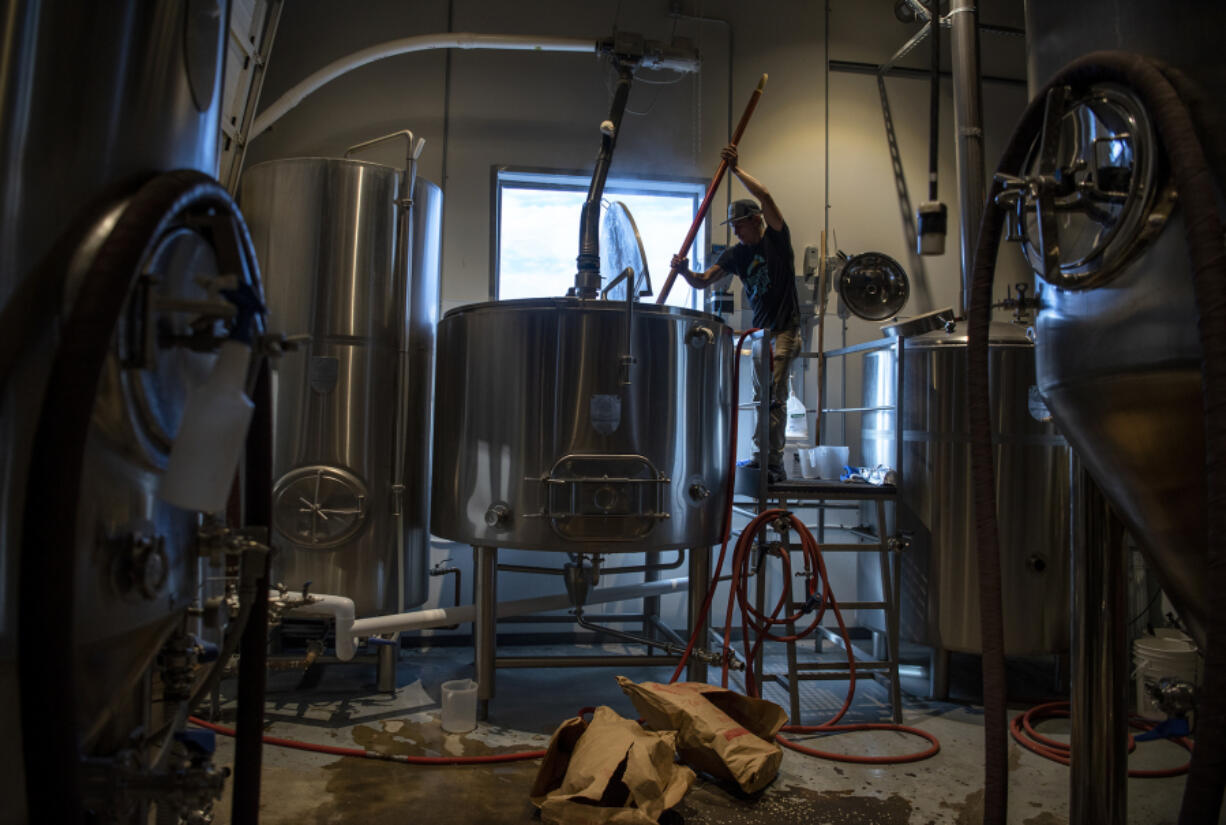 Brothers Cascadia brewer Matt Fields works on the mashing process at the brewery in Hazel Dell in 2019.